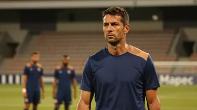 A 35-year-old, 5'10" athletic coach with a strong jawline and short, dark hair, dressed in a plain blue and amber...