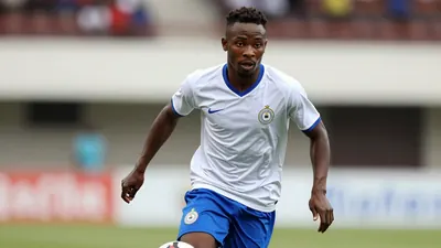 A photorealistic image of a 25-year-old, 5'11'' Ghanaian midfielder in a white and blue kit, with a white shirt and blue...