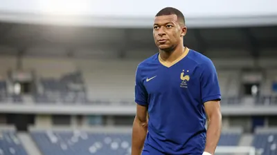 A 35-year-old, ruggedly-built, French midfielder, dressed in a plain, unmarked blue and amber jersey, made from a...