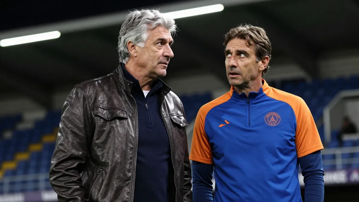 A 35-year-old, 5'10" male coach, with a thick head of graying hair, stands in the low-lit tunnel at Stade de l'Abbé...