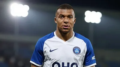 A 25-year-old Auxerre player, with a lean build, in a blue and white kit, waist-up, with a focused expression